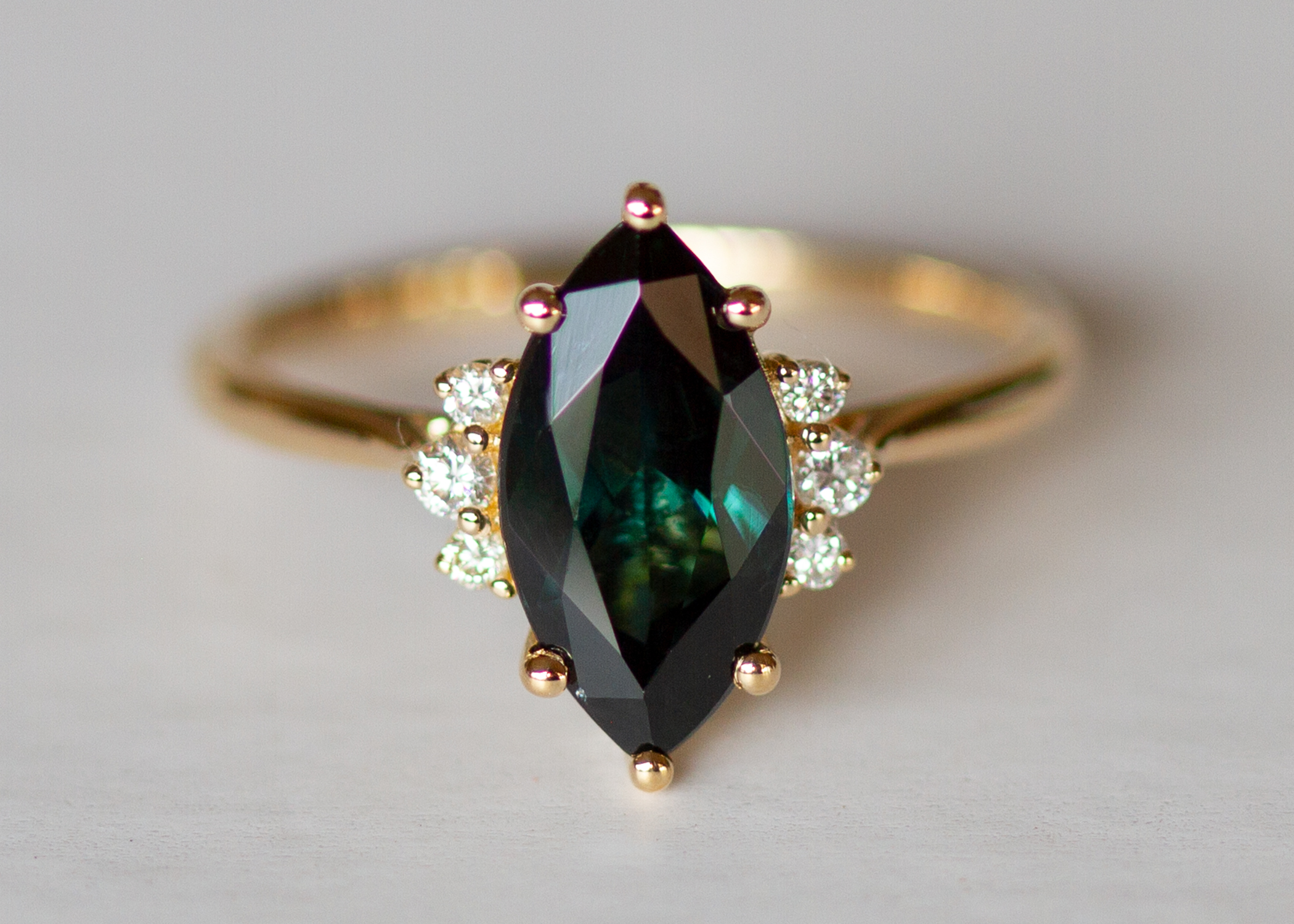 Teal peacock green marquise sapphire and diamond ring