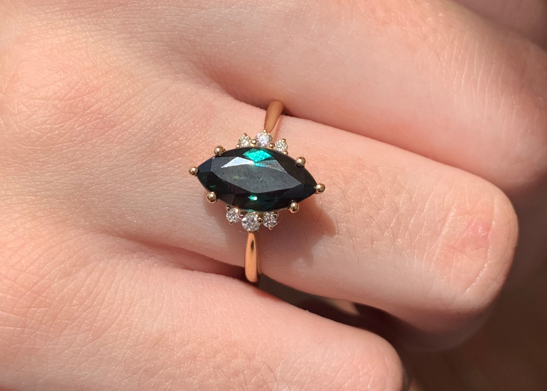 Teal peacock green marquise sapphire and diamond ring