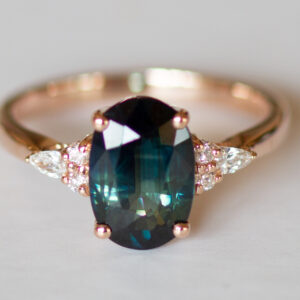 Teal peacock green oval sapphire and diamond ring