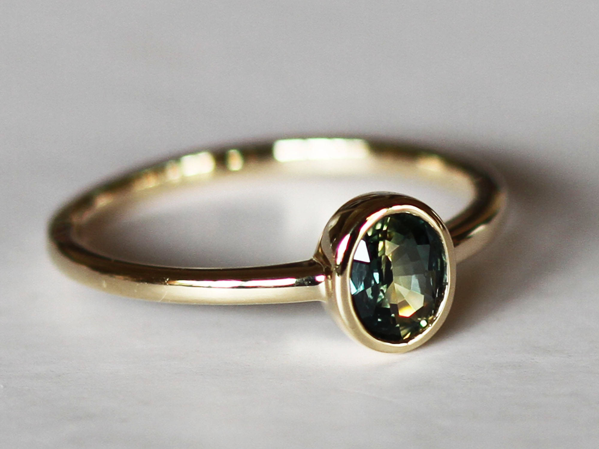 Oval teal petite sapphire gold ring
