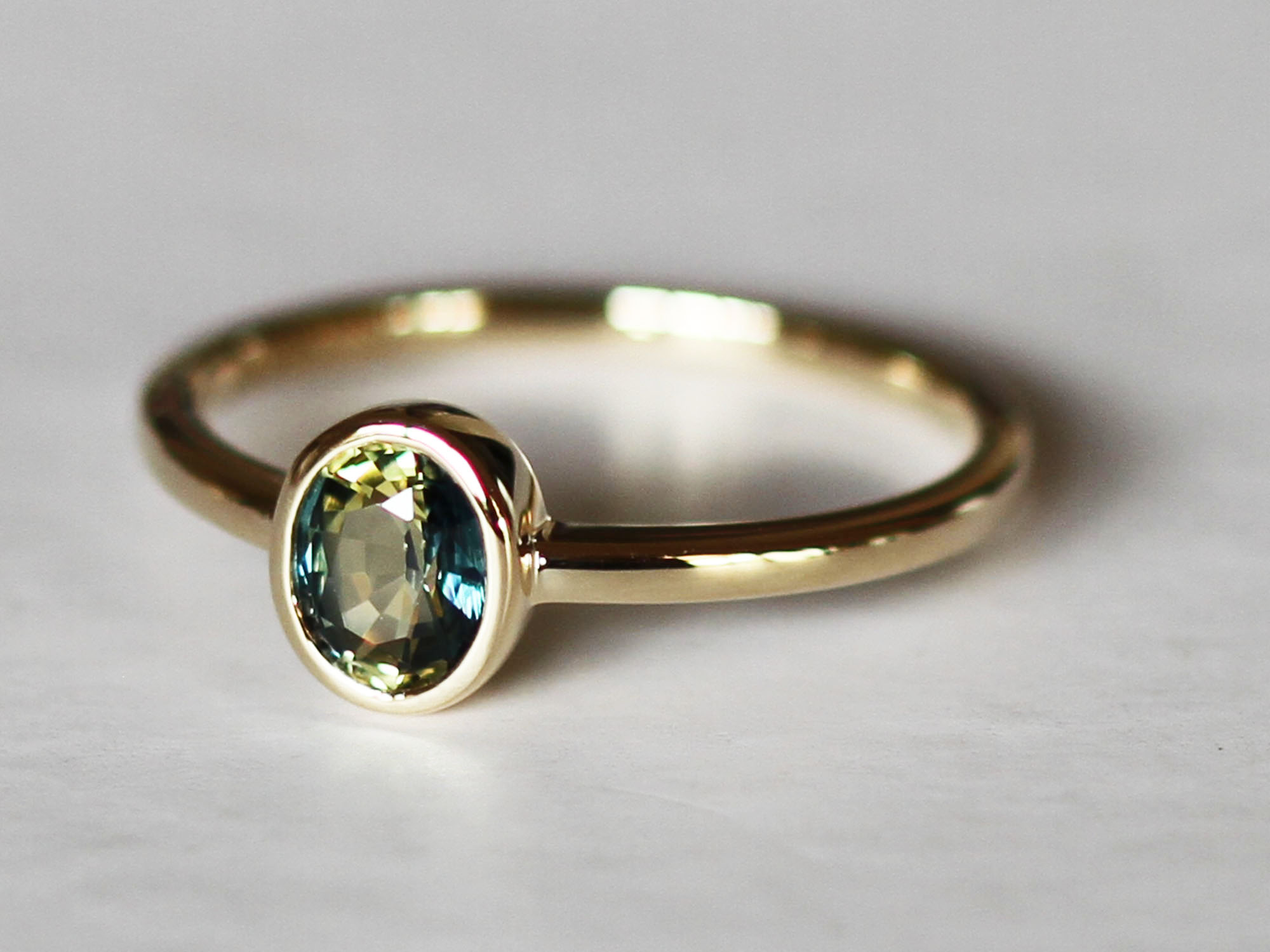 Oval teal petite sapphire gold ring